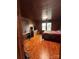 Bedroom with wood flooring and wood paneling, showcasing natural light from windows at 200 Prospect Church Rd, Albemarle, NC 28001