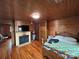 Bedroom with wood flooring and paneling, showcasing a fireplace at 200 Prospect Church Rd, Albemarle, NC 28001