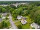 Aerial view of homes with green lawns surrounded by large trees, driveways, and streets at 216 Hillcrest Pl, Salisbury, NC 28144