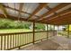 A covered back porch showing a spacious green yard with shade trees at 216 Hillcrest Pl, Salisbury, NC 28144