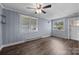 Cozy bedroom featuring a ceiling fan, wood paneling, and natural light at 216 Hillcrest Pl, Salisbury, NC 28144