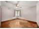 A cozy bedroom with hardwood floors, a ceiling fan, and natural light from a window at 216 Hillcrest Pl, Salisbury, NC 28144