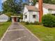 Home exterior featuring a separate garage and covered parking area next to a white picket fence at 216 Hillcrest Pl, Salisbury, NC 28144