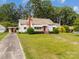 Charming one-story home with a well-maintained lawn and a bright red front door at 216 Hillcrest Pl, Salisbury, NC 28144