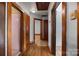 A hallway with hardwood floors and doors leading to various rooms, showing the home's layout at 216 Hillcrest Pl, Salisbury, NC 28144