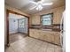 Open kitchen with tile flooring connecting to a living space with wood flooring at 216 Hillcrest Pl, Salisbury, NC 28144