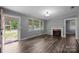 An empty living room features hardwood floors, a fireplace and a door to the outside at 216 Hillcrest Pl, Salisbury, NC 28144