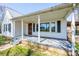 Covered porch showcasing wood door, white columns, and view of front yard at 260 Penninger Dr, Woodleaf, NC 27054