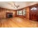 Spacious living room with hardwood floors, a fireplace, and natural light at 260 Penninger Dr, Woodleaf, NC 27054