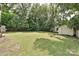 Large backyard with trees and a storage shed at 267 Buffalo Nw Ave, Concord, NC 28025