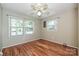 Bedroom with hardwood floors, large windows, a ceiling fan, and neutral paint throughout at 267 Buffalo Nw Ave, Concord, NC 28025