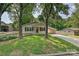 Inviting home showcasing manicured lawn, mature trees, a covered carport and a warm, welcoming entrance at 267 Buffalo Nw Ave, Concord, NC 28025