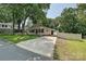 Charming single-story home featuring a covered porch, carport, and a long driveway leading to a well-maintained yard at 267 Buffalo Nw Ave, Concord, NC 28025