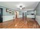 Bright living room featuring beautiful hardwood floors and beadboard wainscotting, open to the kitchen and hallway at 267 Buffalo Nw Ave, Concord, NC 28025