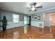 Well-lit living room with hardwood floors and beadboard features, with access to a hallway and view of the front door at 267 Buffalo Nw Ave, Concord, NC 28025
