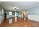 Spacious living room with wood floors and beadboard features, with entrances to the hallway and the front entrance at 267 Buffalo Nw Ave, Concord, NC 28025
