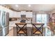 Bright kitchen featuring white cabinets, granite countertops, stainless steel appliances, and counter seating at 2737 Bobcat Rd, Heath Springs, SC 29058