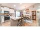 Bright kitchen featuring white cabinets, granite countertops, and a dining area with lots of natural light at 2737 Bobcat Rd, Heath Springs, SC 29058