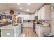 Bright kitchen featuring white cabinets, granite countertops, stainless steel appliances, and light wood flooring at 2737 Bobcat Rd, Heath Springs, SC 29058