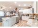 Bright kitchen featuring white cabinets, granite countertops, stainless steel appliances, and light wood flooring at 2737 Bobcat Rd, Heath Springs, SC 29058
