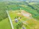 Aerial view of the property's expansive land featuring a pond, home, and outbuilding at 2737 Bobcat Rd, Heath Springs, SC 29058