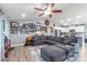 Open concept living space showcasing a large gray sectional, wood floors, and a decorative gallery wall at 2737 Bobcat Rd, Heath Springs, SC 29058