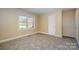 Bedroom featuring tan walls, carpet flooring, and a bright window at 2809 Markland Dr, Charlotte, NC 28208