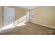 Well-lit bedroom with tan walls, neutral carpet, and ample natural light at 2809 Markland Dr, Charlotte, NC 28208