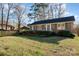 A well-maintained brick house with neat landscaping and a convenient carport, showcasing suburban charm at 2809 Markland Dr, Charlotte, NC 28208