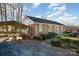 A brick home with a carport boasts a tidy landscape, complemented by green shutters and a well-kept driveway at 2809 Markland Dr, Charlotte, NC 28208