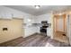 Bright kitchen features white cabinets, modern appliances, and sleek wood floors, blending style and functionality at 2809 Markland Dr, Charlotte, NC 28208