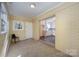 Cozy sunroom with brick walls, plush carpeting, and sliding glass doors, offers seamless indoor-outdoor living at 2809 Markland Dr, Charlotte, NC 28208