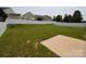 Expansive backyard featuring lush green grass, privacy fencing, and a concrete patio area at 3014 Green Apple Dr, Dallas, NC 28034