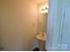 Neat powder room featuring a pedestal sink and neutral paint at 3014 Green Apple Dr, Dallas, NC 28034