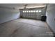 Spacious garage area with concrete flooring and a large overhead door, ready for vehicles and storage at 3014 Green Apple Dr, Dallas, NC 28034