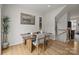 Dining area with a wood table, modern chairs, decor, and view to the stairs at 3108 Beeler Ln, Charlotte, NC 28208