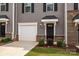 Close up of the garage and front door with black accents and landscaped yard at 3108 Beeler Ln, Charlotte, NC 28208