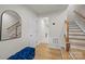 Hallway with wood floors, bench, and staircase at 3108 Beeler Ln, Charlotte, NC 28208