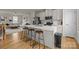 Modern kitchen with stainless steel appliances, white cabinetry, an island, and barstool seating at 3108 Beeler Ln, Charlotte, NC 28208