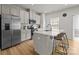 Bright kitchen with white cabinets, stainless steel appliances, and an island with seating at 3108 Beeler Ln, Charlotte, NC 28208