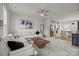 Open-concept living room with white sofa, wood coffee table, kitchen view at 3108 Beeler Ln, Charlotte, NC 28208