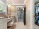 Bright bathroom featuring tiled walls, a walk-in closet, and a vanity with ample counter space at 315 Mountainview Dr, Charlotte, NC 28270