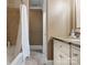 Well-lit bathroom features a shower with a curtain, vanity with storage, and neutral tones at 315 Mountainview Dr, Charlotte, NC 28270