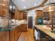Kitchen featuring wooden cabinets, granite countertops, stainless steel appliances, and hardwood floors at 315 Mountainview Dr, Charlotte, NC 28270