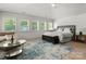 Bright main bedroom with large windows, hardwood floors, and a comfortable sitting area, offering a relaxing retreat at 315 Mountainview Dr, Charlotte, NC 28270