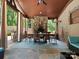 Spacious outdoor dining area with stone fireplace, ceiling fan, and views of the backyard at 315 Mountainview Dr, Charlotte, NC 28270