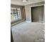 Cozy bedroom featuring neutral carpet, a large window, and ample closet space for a comfortable and relaxing retreat at 3217 Celanese Rd, Rock Hill, SC 29732