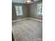 Neutral-toned bedroom with plush carpeting, windows for natural light, and simple design elements for a serene atmosphere at 3217 Celanese Rd, Rock Hill, SC 29732