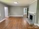 Spacious living room boasts hardwood floors and a striking fireplace, perfect for cozy gatherings and comfortable living at 3217 Celanese Rd, Rock Hill, SC 29732
