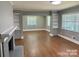 Expansive living room featuring hardwood floors, built-in bookshelves, and large windows that fill the space with natural light at 3217 Celanese Rd, Rock Hill, SC 29732